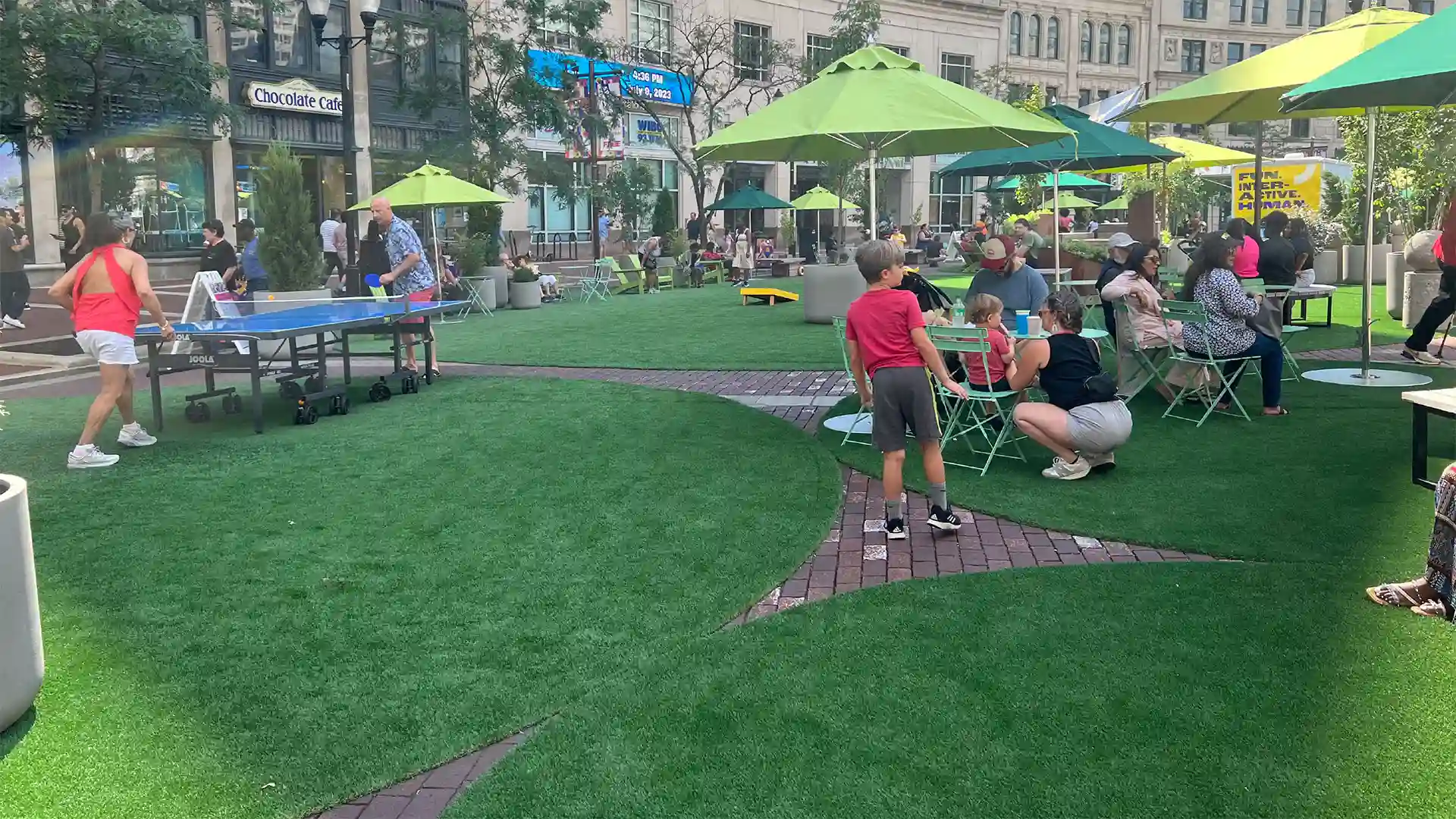 SYNLawn artificial grass at historic Monument Circle Park Indianapolis Indiana image of people enjoying the outdoors on SYNLawn artificial grass at historic Monument Circle Park Indianapolis Indiana